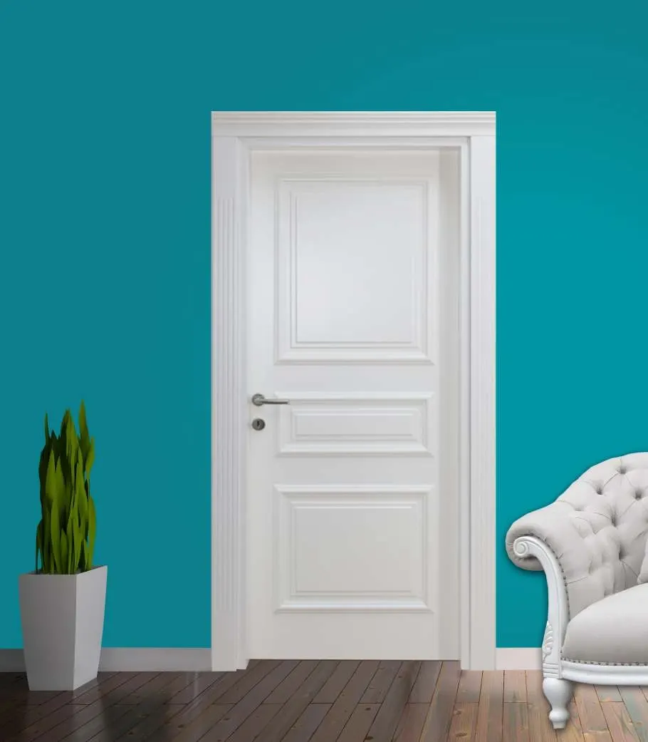 White three-panel door on a teal wall beside a tufted armchair
